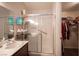 Well-lit bathroom with a glass-enclosed shower, single sink, and open closet at 7231 Sequoia Springs Dr, Las Vegas, NV 89147