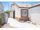 Side entrance of a cozy single-story home featuring a concrete walkway and desert landscaping at 7231 Sequoia Springs Dr, Las Vegas, NV 89147