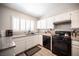 Bright kitchen with white cabinets, stainless steel appliances, and granite countertops at 7231 Sequoia Springs Dr, Las Vegas, NV 89147