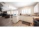Open eat-in kitchen connects to the living area, featuring wood floors, bright cabinets, and a breakfast bar at 7231 Sequoia Springs Dr, Las Vegas, NV 89147