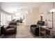 Spacious open-concept living area with natural light, wood flooring and modern furniture at 7231 Sequoia Springs Dr, Las Vegas, NV 89147