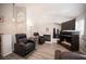 Bright living room offers fireplace, wood floors and neutral walls, creating a relaxing ambiance at 7231 Sequoia Springs Dr, Las Vegas, NV 89147