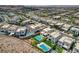 Aerial view shows desert community homes with modern architecture, complemented by desert landscaping and pools at 734 Glowing Horizon St, Henderson, NV 89052