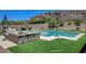 Relaxing backyard oasis with a sparkling pool, spa, and comfortable outdoor seating at 734 Glowing Horizon St, Henderson, NV 89052