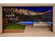 Covered patio view of a backyard with a pool, spa, fire pit, and lush landscaping at 734 Glowing Horizon St, Henderson, NV 89052
