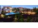 Backyard pool and landscaping with ambient lighting at 734 Glowing Horizon St, Henderson, NV 89052
