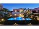 Backyard featuring a modern pool, fire pit and lush landscaping at 734 Glowing Horizon St, Henderson, NV 89052