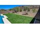 Lush backyard featuring artificial turf and desert landscaping for low maintenance and year-round beauty at 734 Glowing Horizon St, Henderson, NV 89052
