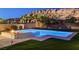 Beautiful backyard featuring a pool, spa, fire pit, and lush landscaping at 734 Glowing Horizon St, Henderson, NV 89052