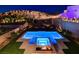 Beautiful backyard with a modern pool, spa, and fire pit, perfect for outdoor entertaining and relaxation at 734 Glowing Horizon St, Henderson, NV 89052