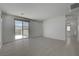 Bright bedroom featuring tile flooring, neutral paint and sliding glass door leading to a private balcony at 734 Glowing Horizon St, Henderson, NV 89052
