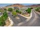 Community entrance with desert landscaping and a stone 