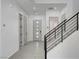 Bright entryway with modern staircase, and light tile flooring creating an airy feel at 734 Glowing Horizon St, Henderson, NV 89052