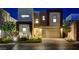 Contemporary home featuring a well-manicured lawn, desert landscaping, and an attached two-car garage at 734 Glowing Horizon St, Henderson, NV 89052
