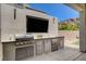 This outdoor kitchen includes stainless steel appliances, counter space, and a built-in grill at 734 Glowing Horizon St, Henderson, NV 89052