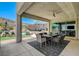 Outdoor living space featuring a covered patio, outdoor kitchen, and pool with mountain views at 734 Glowing Horizon St, Henderson, NV 89052