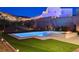 Backyard featuring a pool, spa, fire pit, lush lawn and mountain views at 734 Glowing Horizon St, Henderson, NV 89052