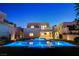 Gorgeous backyard with a sleek pool, spa, fire pit, and modern home exterior at 734 Glowing Horizon St, Henderson, NV 89052