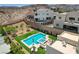 Aerial view of a modern pool and spa with an outdoor firepit and patio seating at 734 Glowing Horizon St, Henderson, NV 89052
