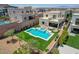Beautiful aerial view of backyard pool and spa with outdoor seating and lush landscaping at 734 Glowing Horizon St, Henderson, NV 89052
