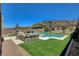 Backyard featuring a pool, spa, lush lawn, and comfortable lounge furniture at 734 Glowing Horizon St, Henderson, NV 89052