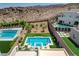 Aerial view of a modern pool and landscaped backyard in a desert setting at 734 Glowing Horizon St, Henderson, NV 89052