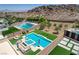 Aerial view highlighting the pool, spa, outdoor seating, and mountain views at 734 Glowing Horizon St, Henderson, NV 89052