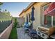 Relaxing backyard featuring a grill, seating, a small tree, and a view of the neighborhood at 7472 Brody Meadows St, North Las Vegas, NV 89084