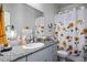 Bright bathroom features a sunflower shower curtain and granite countertops at 7472 Brody Meadows St, North Las Vegas, NV 89084
