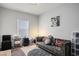 Cozy bedroom area includes a couch and desk, perfect for relaxing or working from home at 7472 Brody Meadows St, North Las Vegas, NV 89084