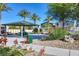 Community pool area with picnic tables, a barbecue, and shade trees at 7472 Brody Meadows St, North Las Vegas, NV 89084