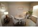 Cozy dining area featuring a round table, comfortable chairs, and ample natural light at 7472 Brody Meadows St, North Las Vegas, NV 89084