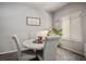 Cozy dining area features neutral colors, a round table with upholstered chairs, and lots of natural light at 7472 Brody Meadows St, North Las Vegas, NV 89084