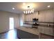 Bright kitchen featuring granite countertops, stainless appliances, and sliding door to the backyard at 7472 Brody Meadows St, North Las Vegas, NV 89084