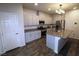 Modern kitchen featuring white cabinets, stainless steel appliances, and a functional island at 7472 Brody Meadows St, North Las Vegas, NV 89084