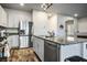 Well-lit kitchen with granite countertops, stainless steel refrigerator and modern cabinets at 7472 Brody Meadows St, North Las Vegas, NV 89084