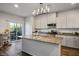 Modern kitchen boasts granite countertops, stainless steel appliances, ample cabinetry, and a breakfast bar at 7472 Brody Meadows St, North Las Vegas, NV 89084
