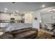 Inviting living room open to the kitchen featuring stainless steel appliances and modern lighting at 7472 Brody Meadows St, North Las Vegas, NV 89084