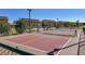 Community tennis and pickleball court with fencing, benches, and surrounding landscaping at 7472 Brody Meadows St, North Las Vegas, NV 89084