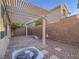 The backyard with pergola provides shade to a brick patio and features gravel accents at 7605 Lake Fork Peak St, Las Vegas, NV 89166