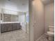 Bathroom with double vanity, soaking tub, and tiled floor at 7605 Lake Fork Peak St, Las Vegas, NV 89166