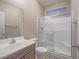 Bright bathroom with glass shower, vanity, mirror, and toilet at 7605 Lake Fork Peak St, Las Vegas, NV 89166