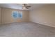 Large bedroom with carpeting and a big bright window at 7605 Lake Fork Peak St, Las Vegas, NV 89166