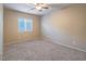 Neutral bedroom showcasing a ceiling fan and a window for natural light at 7605 Lake Fork Peak St, Las Vegas, NV 89166