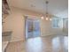 Open concept dining area features sliding glass door and modern lighting at 7605 Lake Fork Peak St, Las Vegas, NV 89166