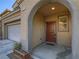 Arched covered entryway features a solid front door and a small planter with desert landscaping at 7605 Lake Fork Peak St, Las Vegas, NV 89166
