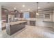 Open kitchen with stainless appliances, granite countertops, and island seating at 7605 Lake Fork Peak St, Las Vegas, NV 89166