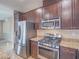 Bright kitchen with stainless appliances and granite countertops for meal prep at 7605 Lake Fork Peak St, Las Vegas, NV 89166