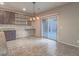 Dining area adjacent to the kitchen offers sliding door to patio and wall shelving at 7605 Lake Fork Peak St, Las Vegas, NV 89166
