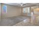 Living room with carpet, a window, and an open view to the entryway and adjacent living space at 7605 Lake Fork Peak St, Las Vegas, NV 89166